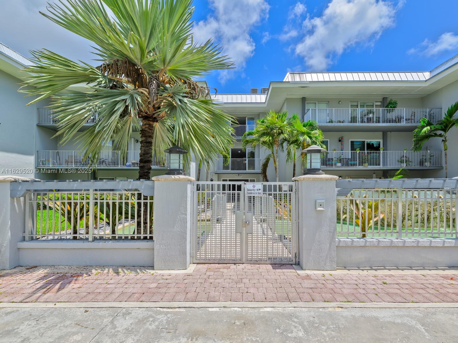 7403 Southwest 82nd Street, Unit 201N Miami, FL 33143 - Photo 3 of 43 a front view of a house with garden