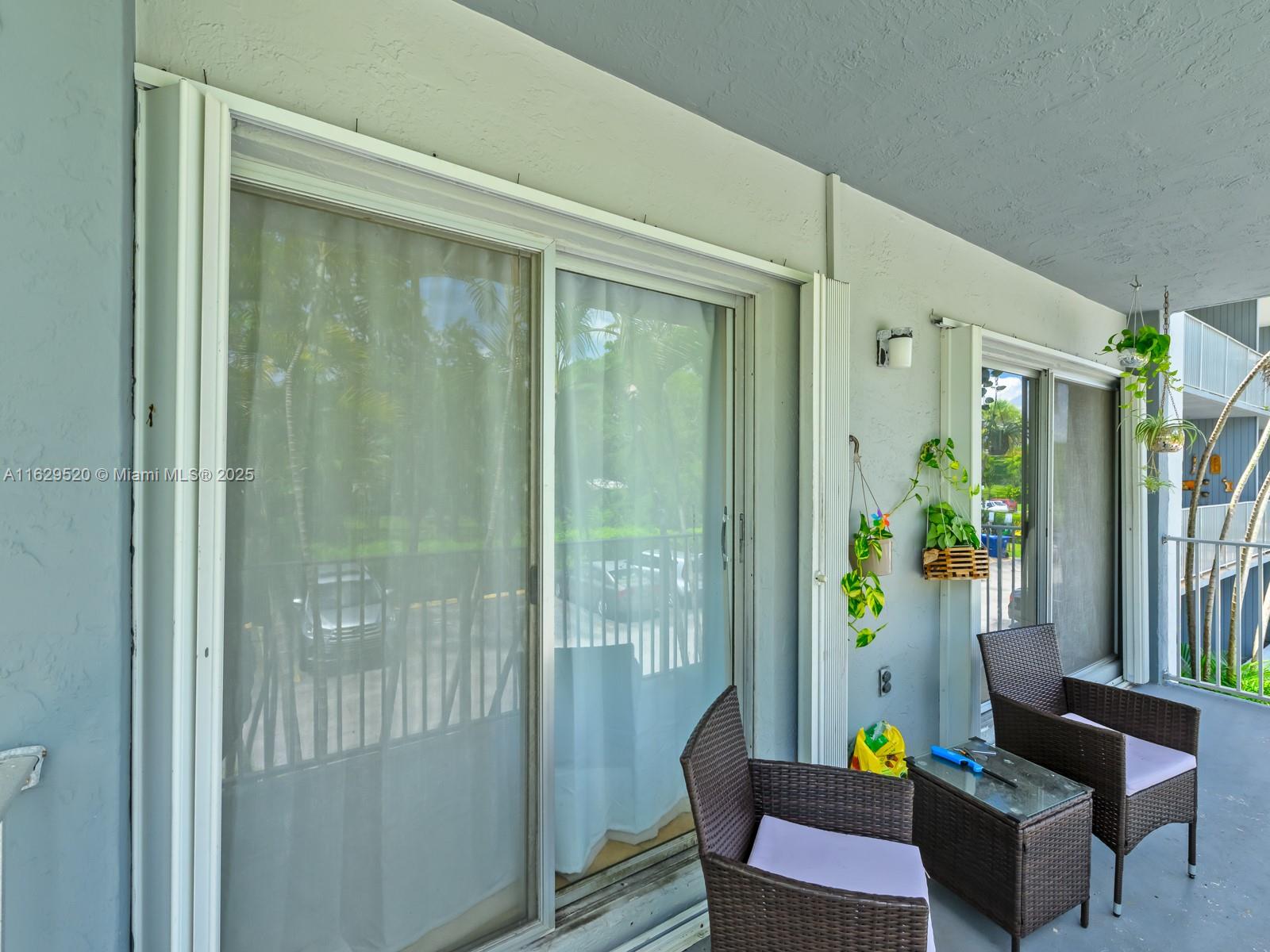 7403 Southwest 82nd Street, Unit 201N Miami, FL 33143 - Photo 32 of 43 a living room with furniture and a potted plant