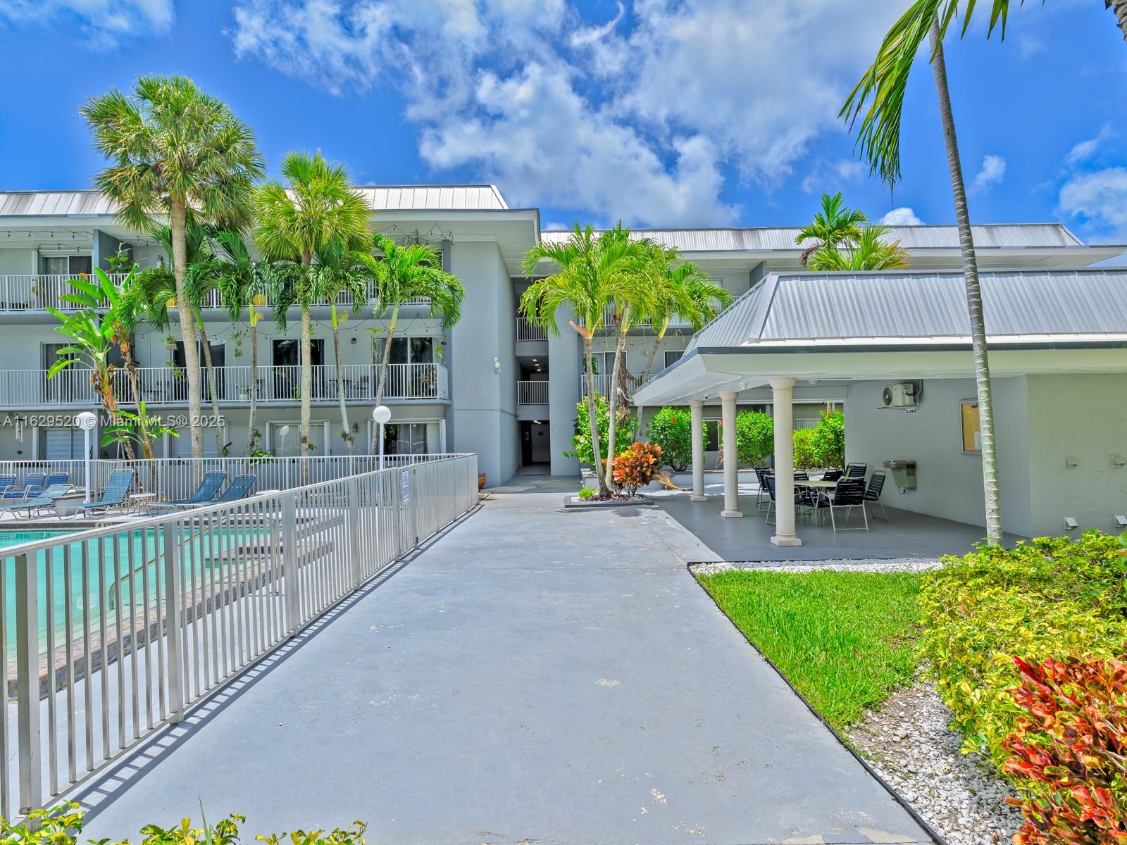 7403 Southwest 82nd Street, Unit 201N Miami, FL 33143 - Photo 36 of 43 a view of a house with porch and a garden