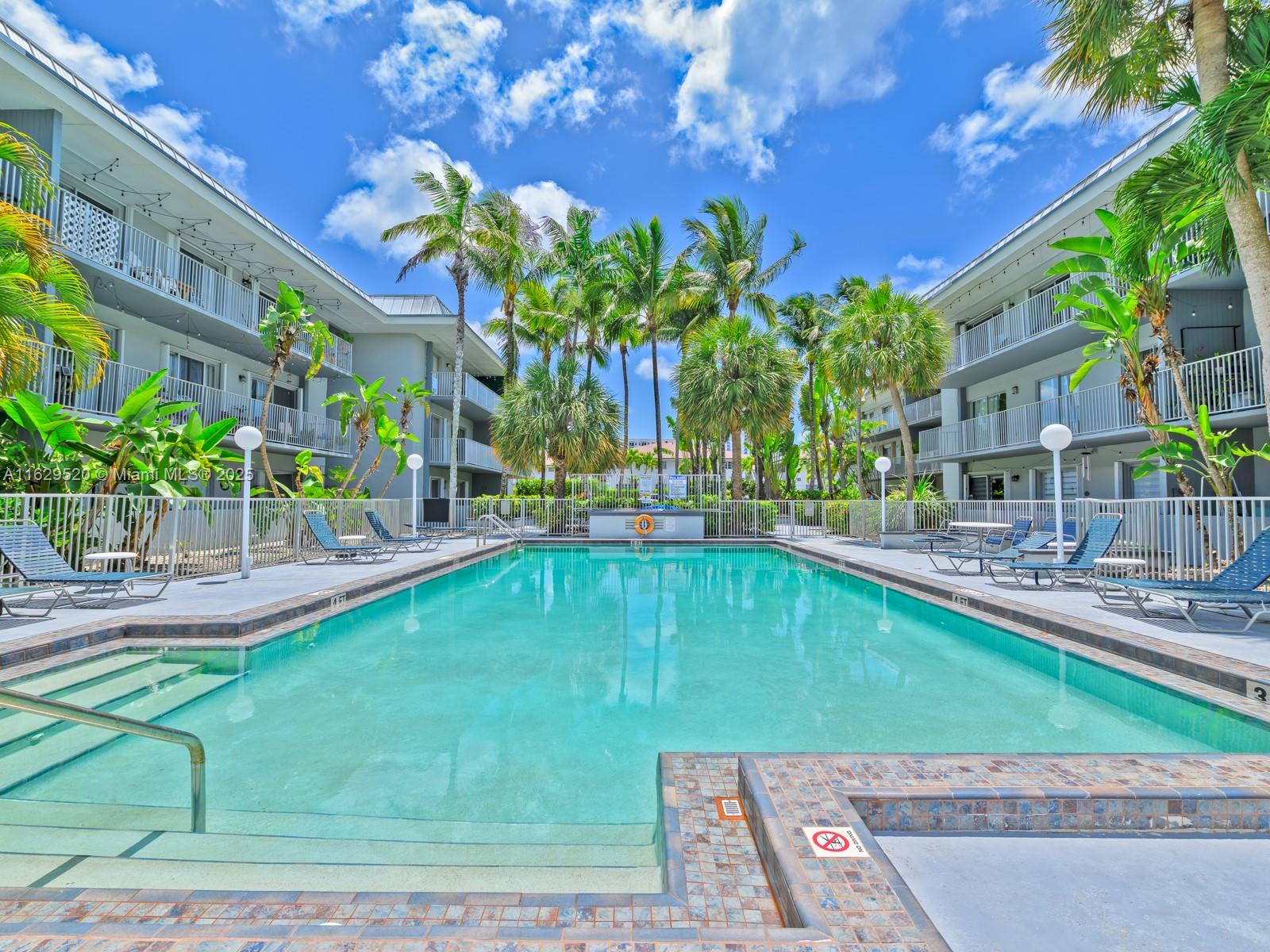 7403 Southwest 82nd Street, Unit 201N Miami, FL 33143 - Photo 37 of 43 a view of a swimming pool with a patio