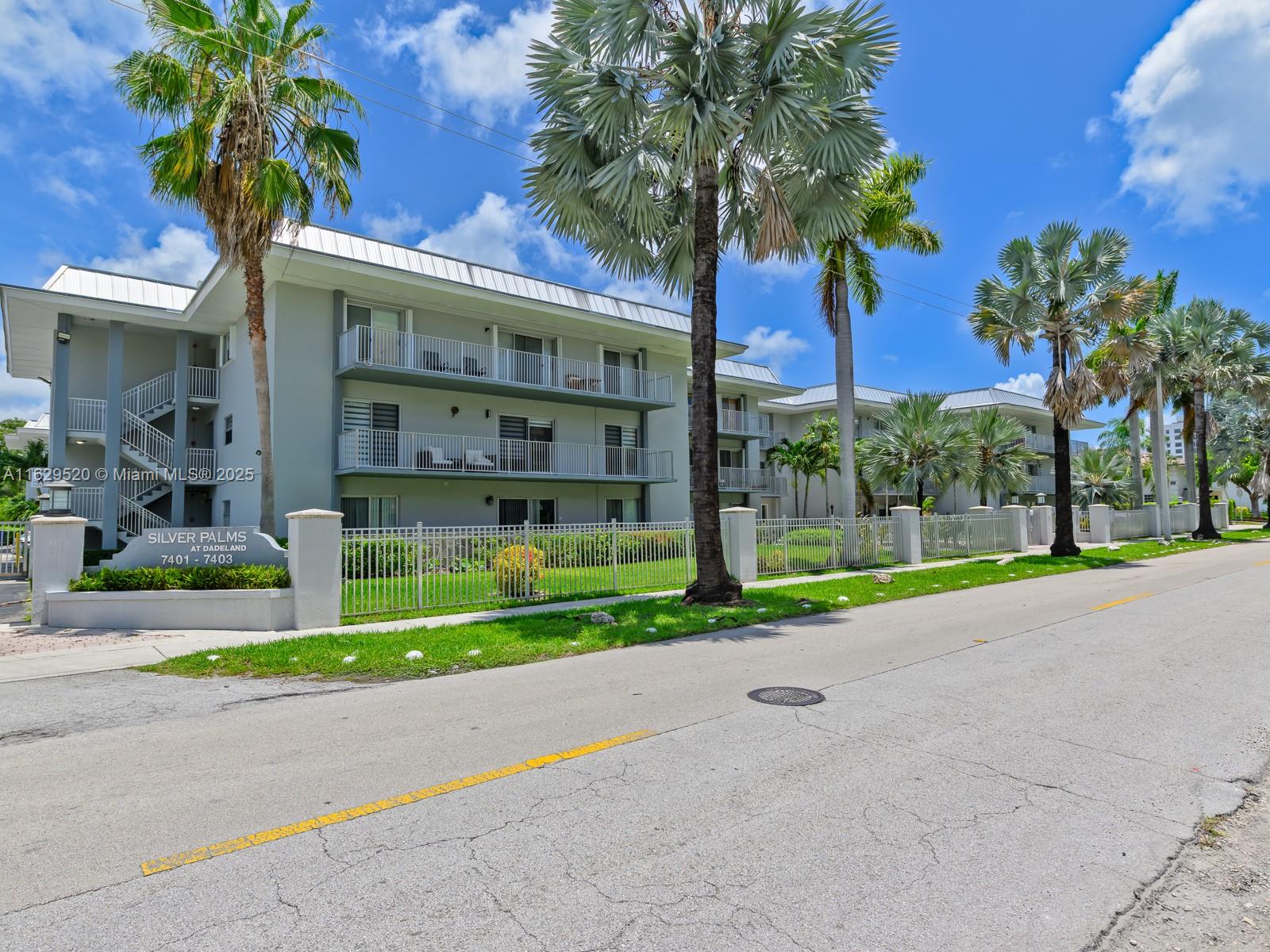 7403 Southwest 82nd Street, Unit 201N Miami, FL 33143 - Photo 42 of 43 a house with palm tree in front of it