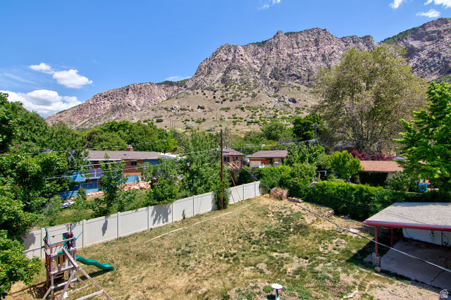 1272 Cook Street Ogden, UT 84404 - Photo 35 of 46 Expansive backyard featuring a white privacy fence and a mountain backdrop