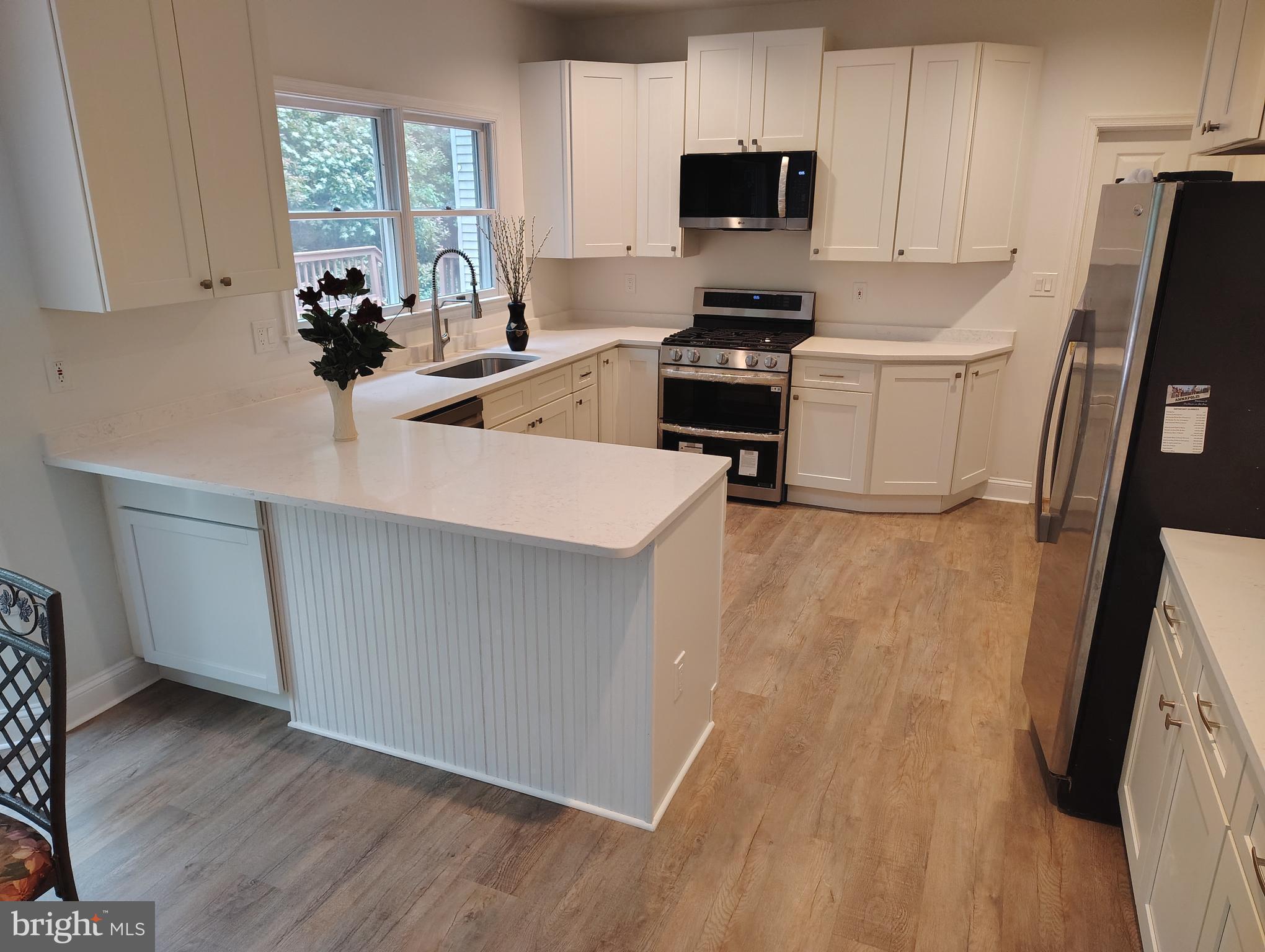 1711 Ritchie Highway Annapolis, MD 21409 - Photo 11 of 16 a kitchen with cabinets a sink a window and appliances