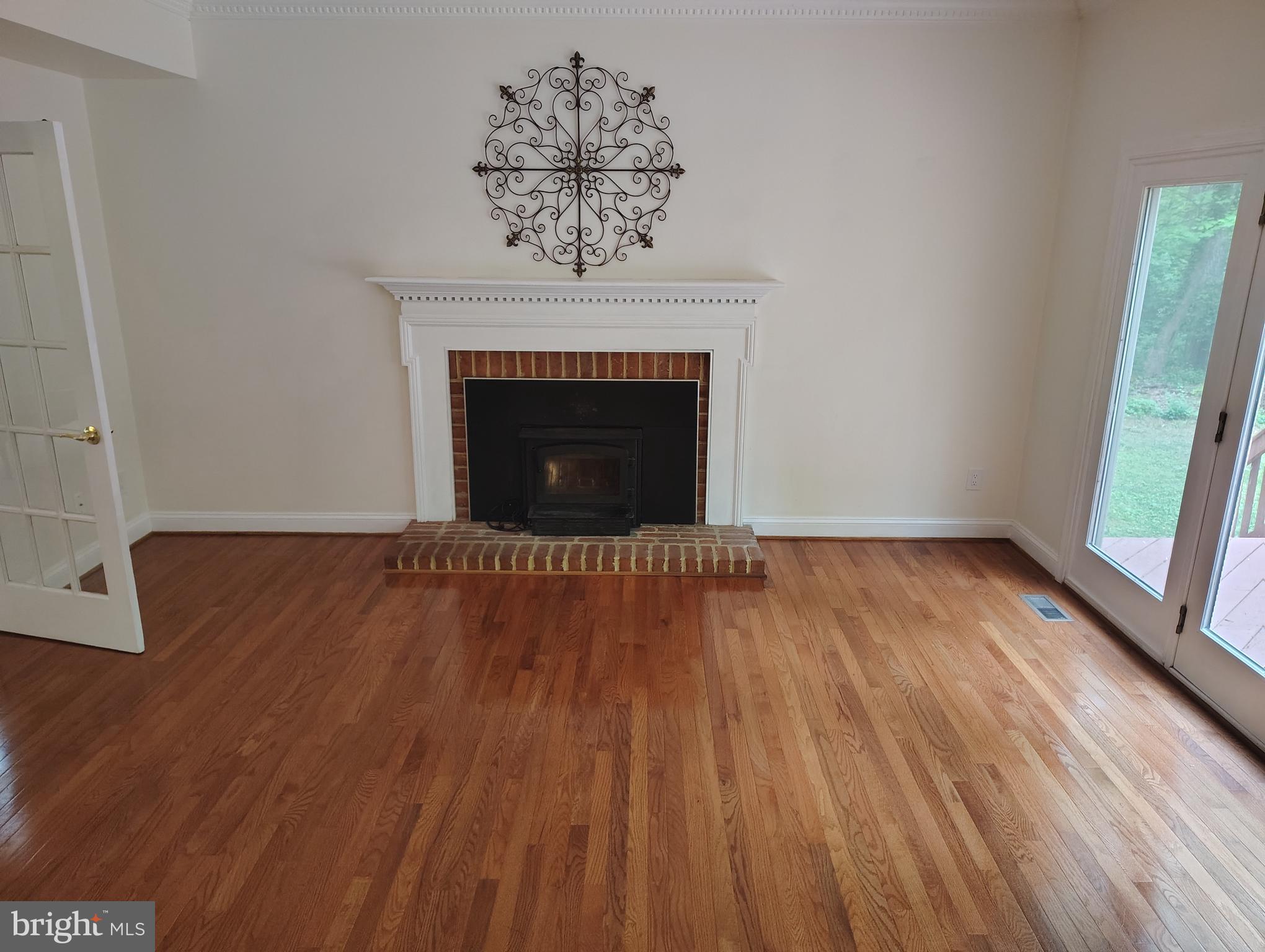 1711 Ritchie Highway Annapolis, MD 21409 - Photo 13 of 16 a view of an empty room with wooden floor and a fireplace