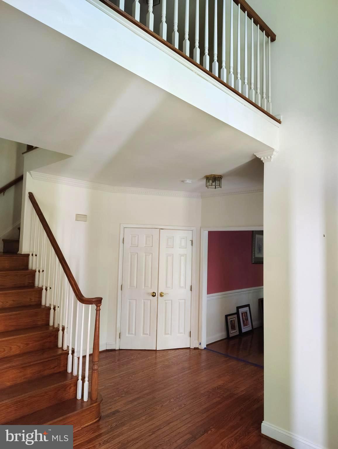 1711 Ritchie Highway Annapolis, MD 21409 - Photo 4 of 16 a view of a hallway with wooden floor staircase and a living room
