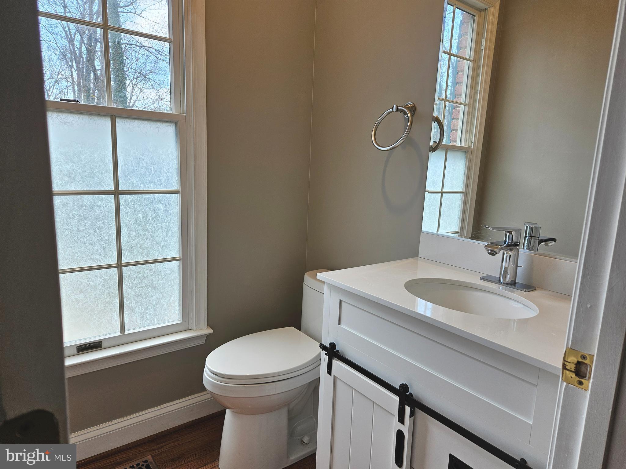 1711 Ritchie Highway Annapolis, MD 21409 - Photo 8 of 16 a bathroom with a sink a toilet and a window