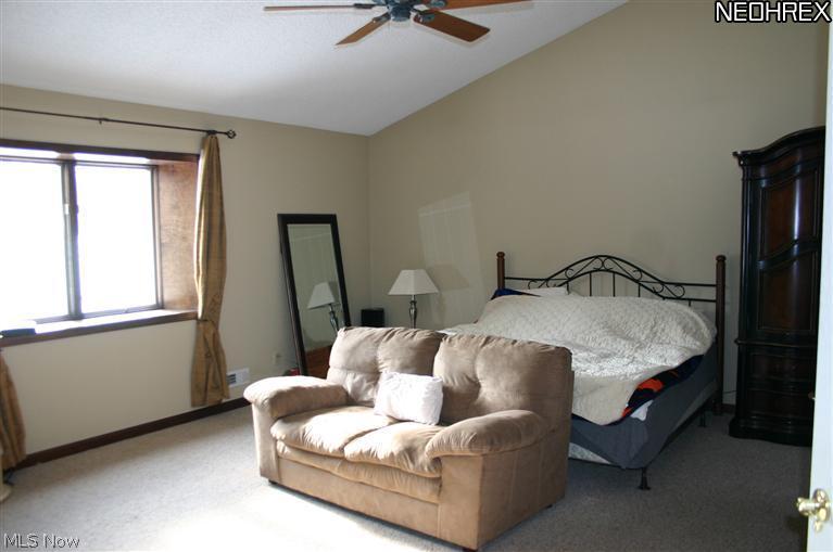 12180 New London Eastern Road Homerville, OH 44235 - Photo 4 of 17 Huge Master Bedroom with vaulted ceilings, 2 way, see through, gas fireplace, and en suite bath.