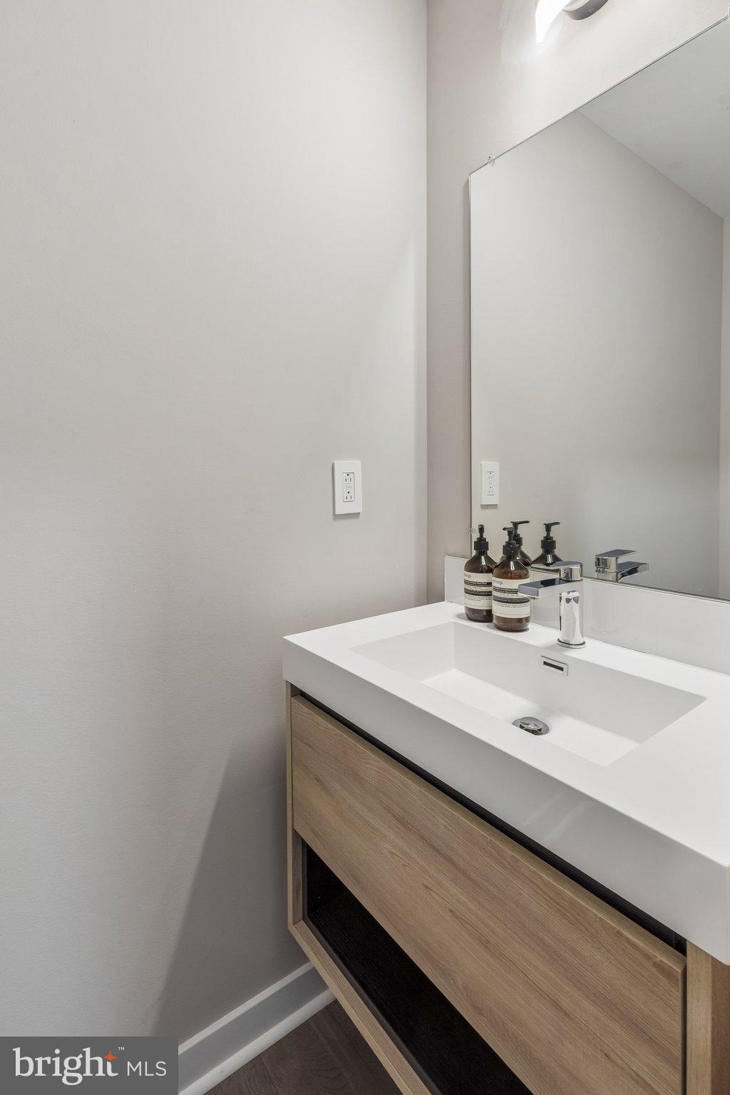 1648-50 Ridge Avenue, Unit 302 Philadelphia, PA 19130 - Photo 29 of 38 a bathroom with a sink and a mirror