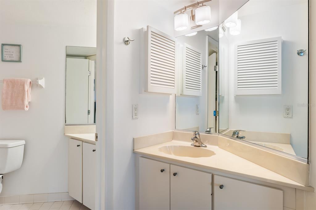 5000 Gasparilla Road, Unit BC105 Boca Grande, FL 33921 - Photo 12 of 33 a bathroom with a sink and a mirror