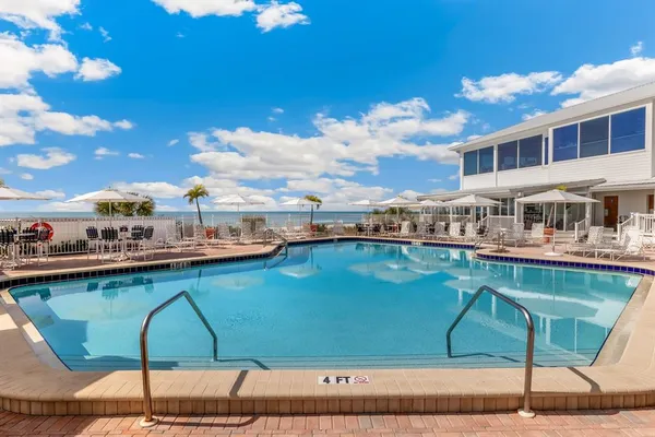 a view of swimming pool with outdoor seating and city view