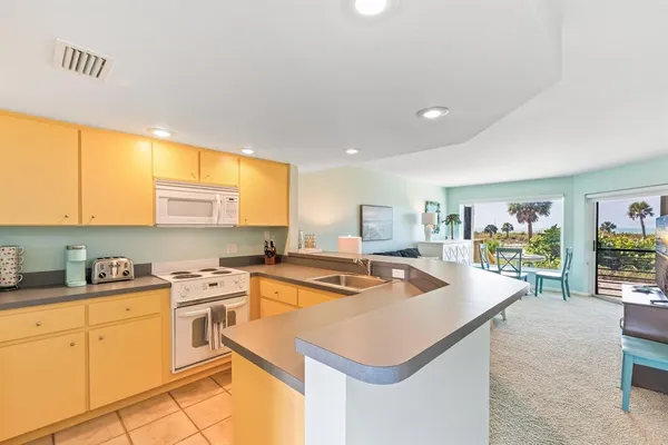 a kitchen that has a sink and a stove in it