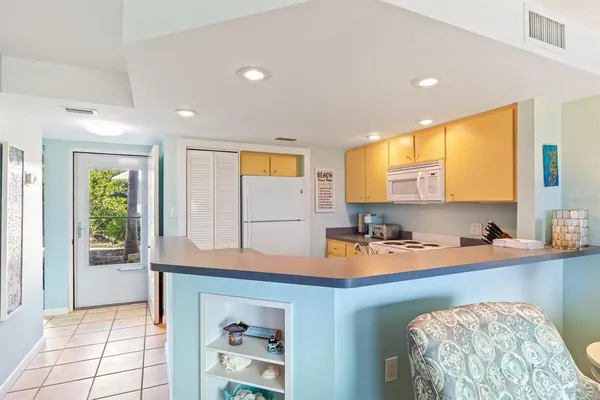 a kitchen with a sink a window and cabinets