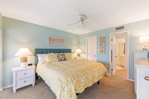 a bedroom with a bed and a lamp