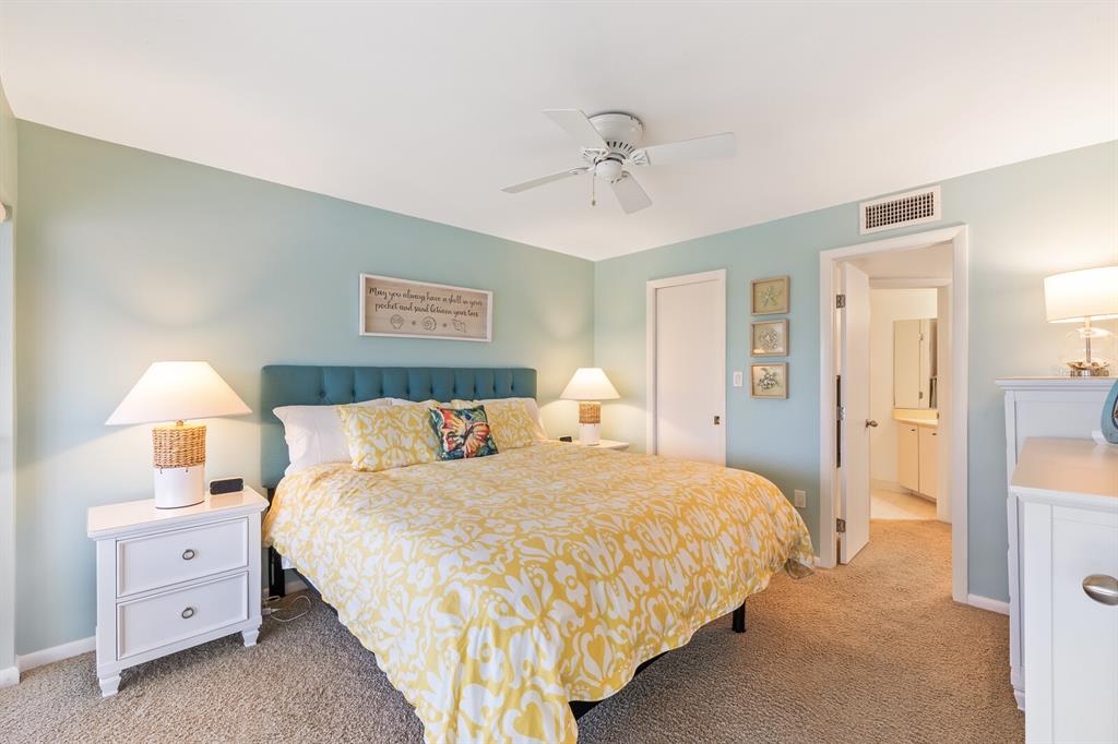 5000 Gasparilla Road, Unit BC105 Boca Grande, FL 33921 - Photo 10 of 33 a bedroom with a bed and a lamp