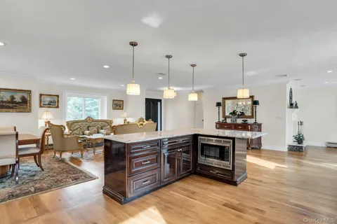 a kitchen with a stove and a wooden floor
