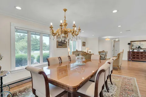 a view of a dining room with furniture wooden floor and chandelier