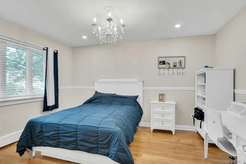 a bedroom with a bed and a chair in it