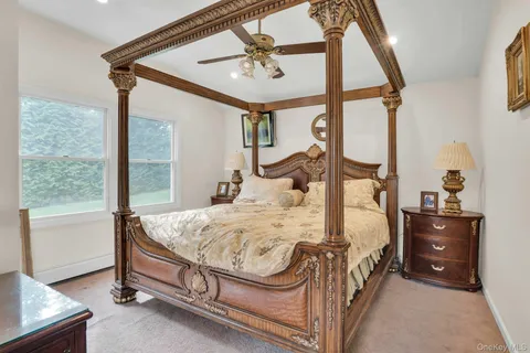 a bedroom with a bed table and window