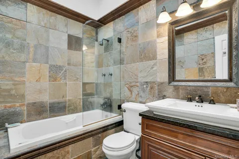 a bathroom with a sink toilet and shower