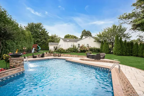 a view of a swimming pool and trees in the background