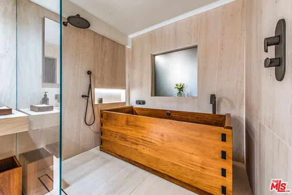a bathroom with a tub and a shower