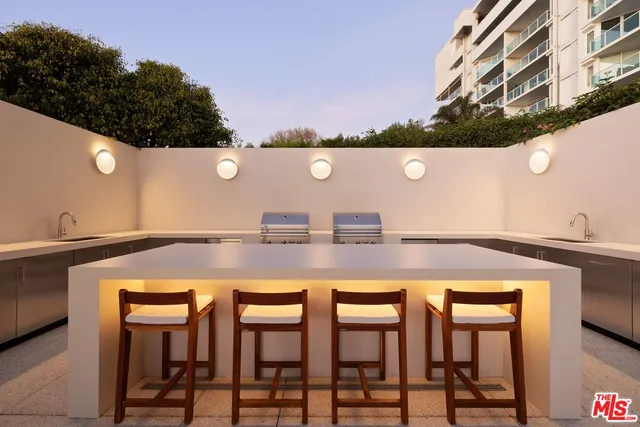 a view of a patio with a table and chairs