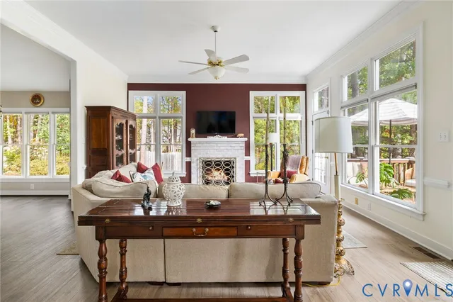 a living room with fireplace furniture and a large window