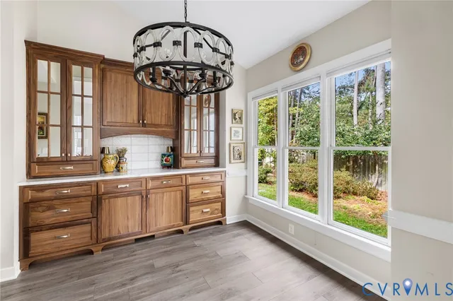 a kitchen with stainless steel appliances granite countertop a stove a sink and a chandelier