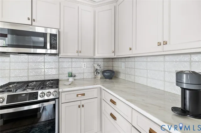 a kitchen with appliances a sink and cabinets