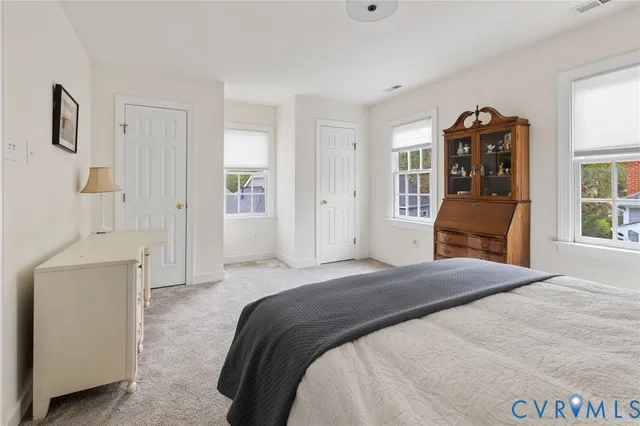 a bedroom with a bed and a mirror