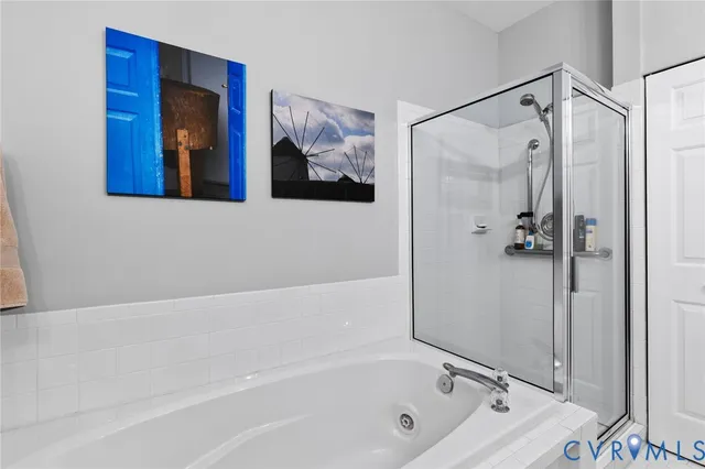 a bathroom with a tub and a shower