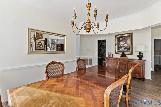 a dining room with wooden floor and breakfast area