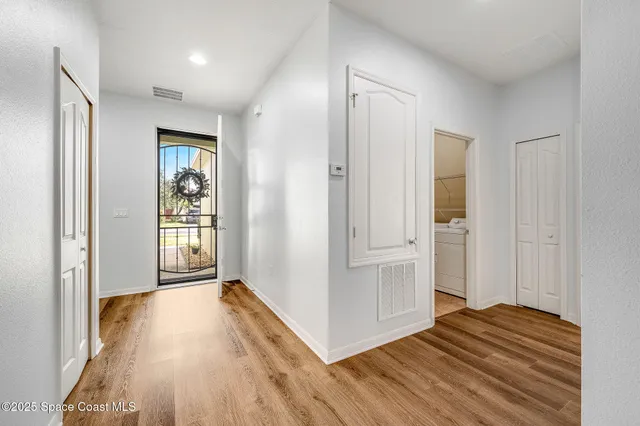 a view of a room with wooden floor and window