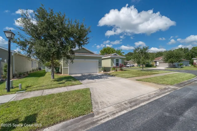 an aerial view of a house with a yard and a large pool