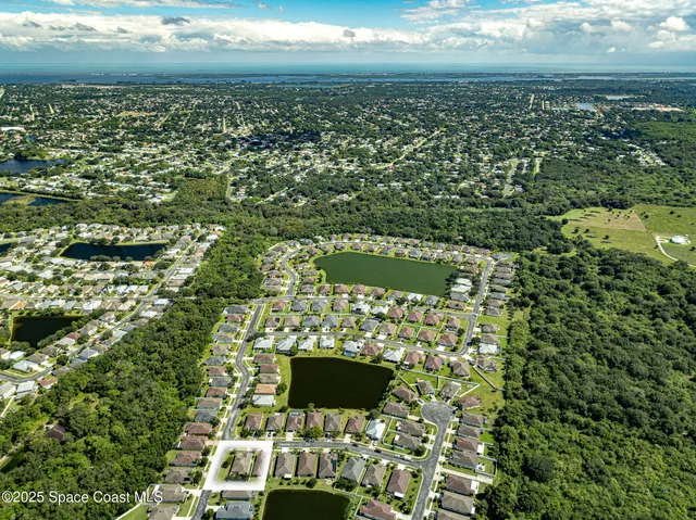 an aerial view of a house with a swimming pool