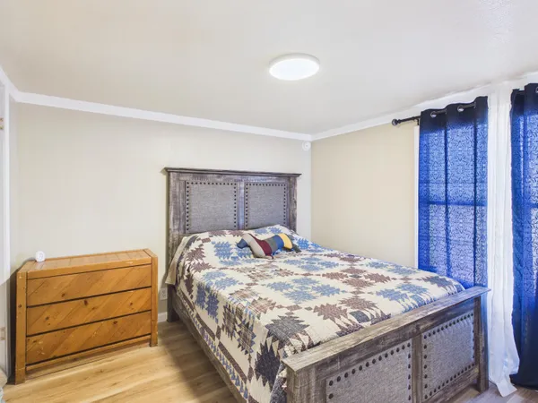 a bedroom with a bed and a window