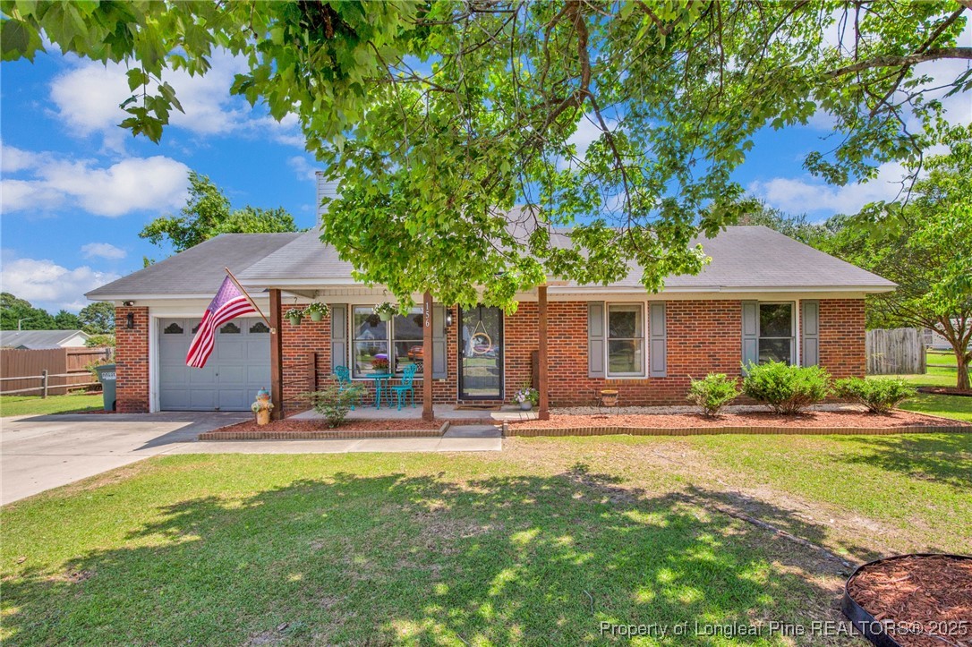 156 Barefoot Road Fayetteville, NC 28306 - Photo 1 of 28 a front view of a house with a yard tree and outdoor seating