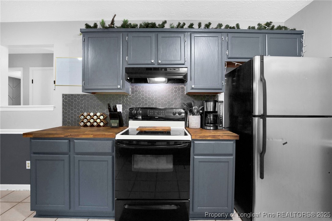 156 Barefoot Road Fayetteville, NC 28306 - Photo 12 of 28 a kitchen with stainless steel appliances granite countertop a refrigerator a sink and a stove