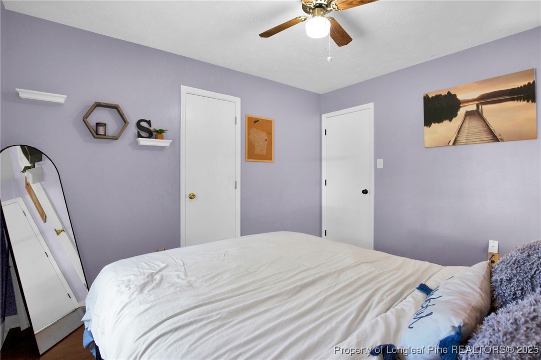 156 Barefoot Road Fayetteville, NC 28306 - Photo 16 of 28 a bedroom with a bed and a chandelier
