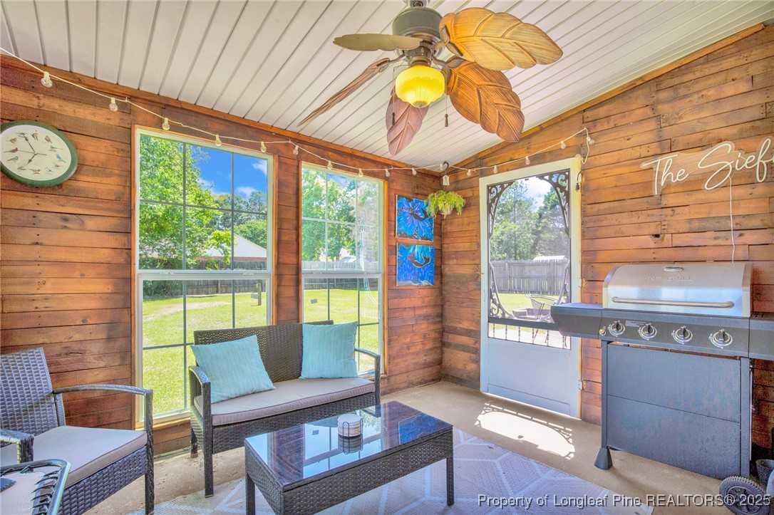 156 Barefoot Road Fayetteville, NC 28306 - Photo 23 of 28 a living room with furniture and a floor to ceiling window