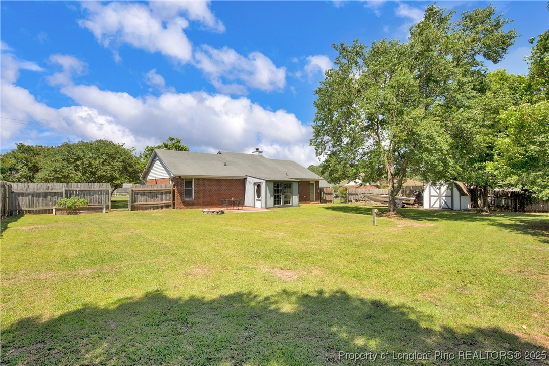 156 Barefoot Road Fayetteville, NC 28306 - Photo 25 of 28 a front view of house with swimming pool and trees in the background