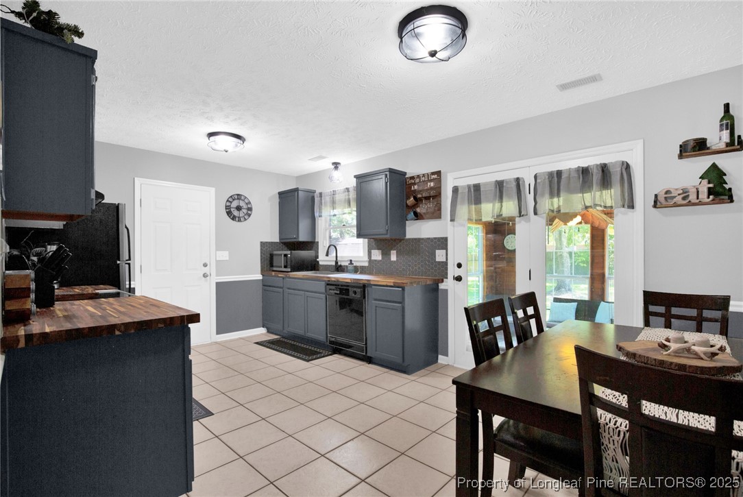 156 Barefoot Road Fayetteville, NC 28306 - Photo 10 of 28 a kitchen with a dining table and chairs