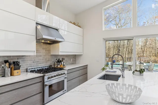 a kitchen with a stove a sink and cabinets