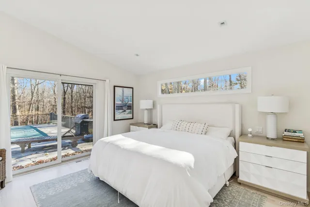 a bedroom with a large bed and a large window