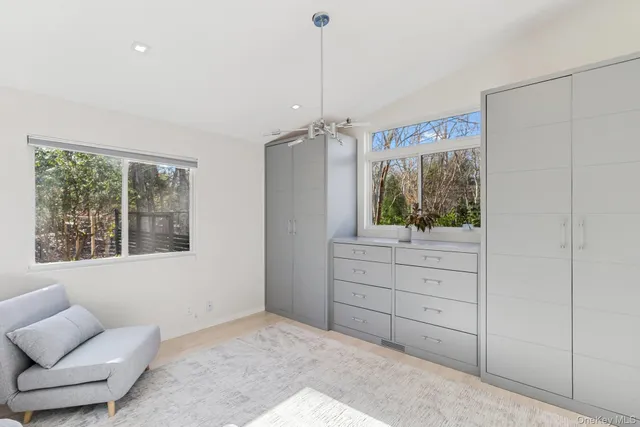 a room with a window and a dresser