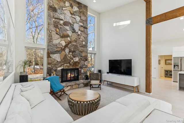 a living room with furniture a fireplace and a flat screen tv
