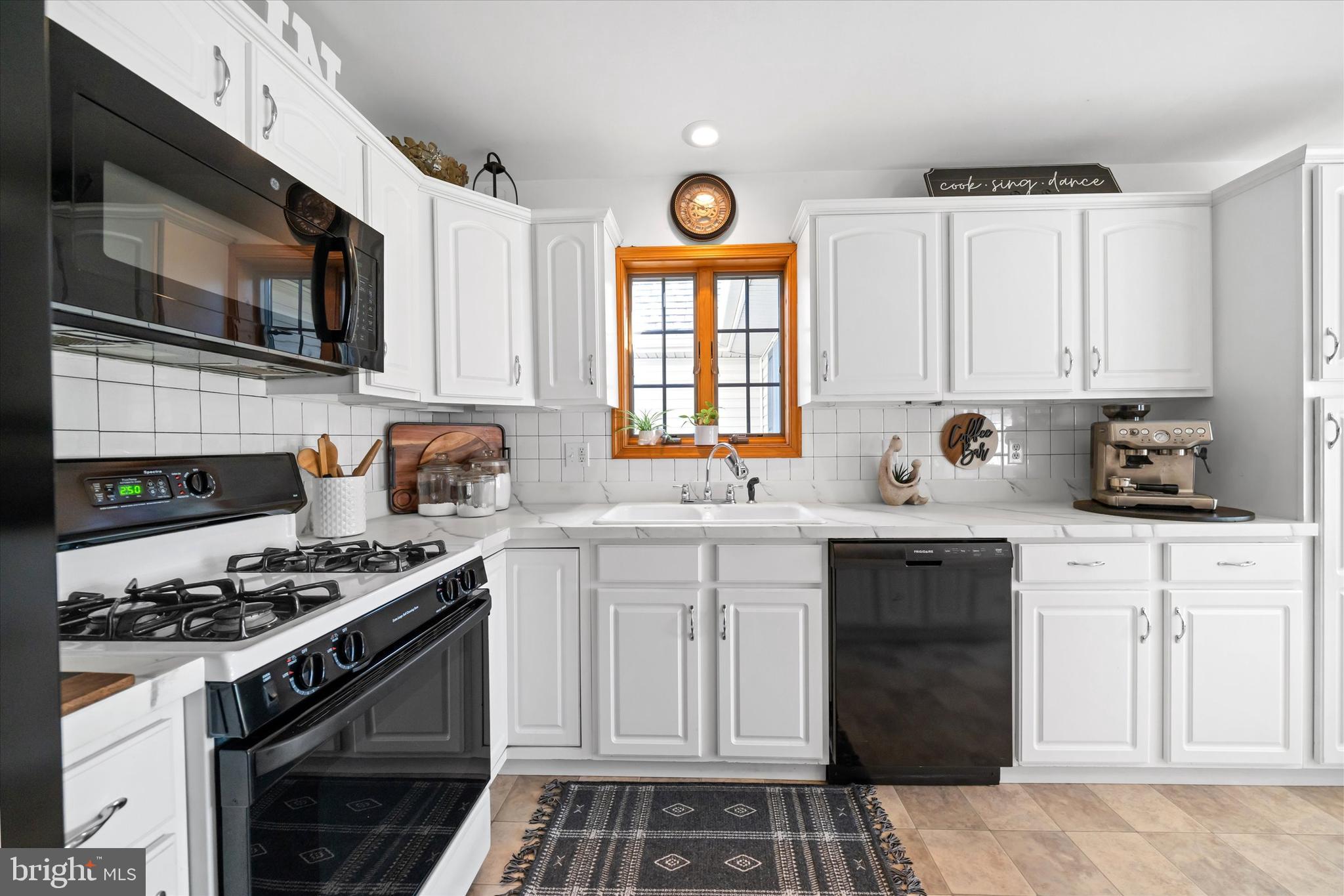 1265 Bowman Road Milford, DE 19963 - Photo 16 of 60 a kitchen with stainless steel appliances granite countertop a stove a sink and a microwave