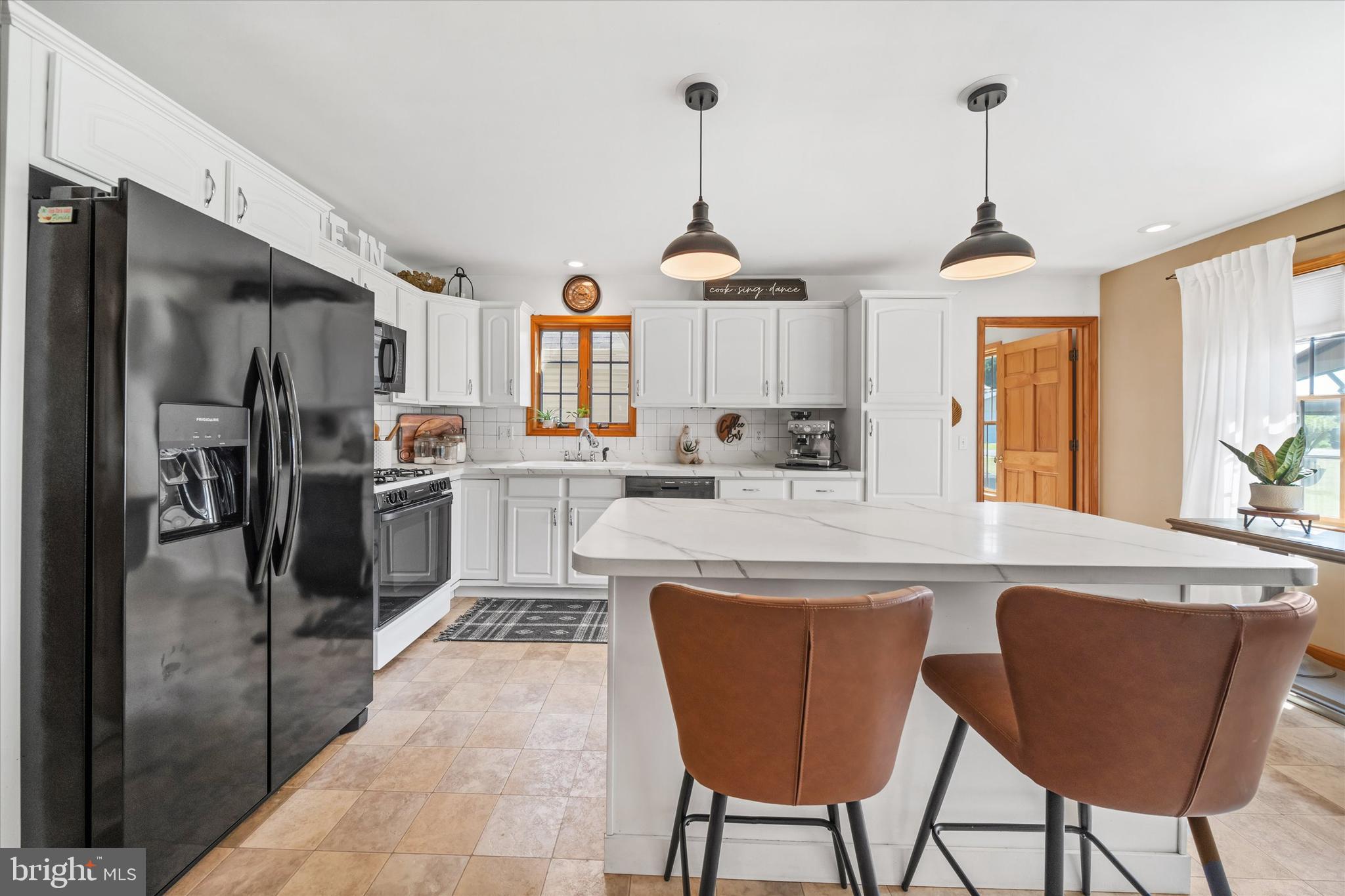 1265 Bowman Road Milford, DE 19963 - Photo 18 of 60 a kitchen with stainless steel appliances a stove a refrigerator and a dining table