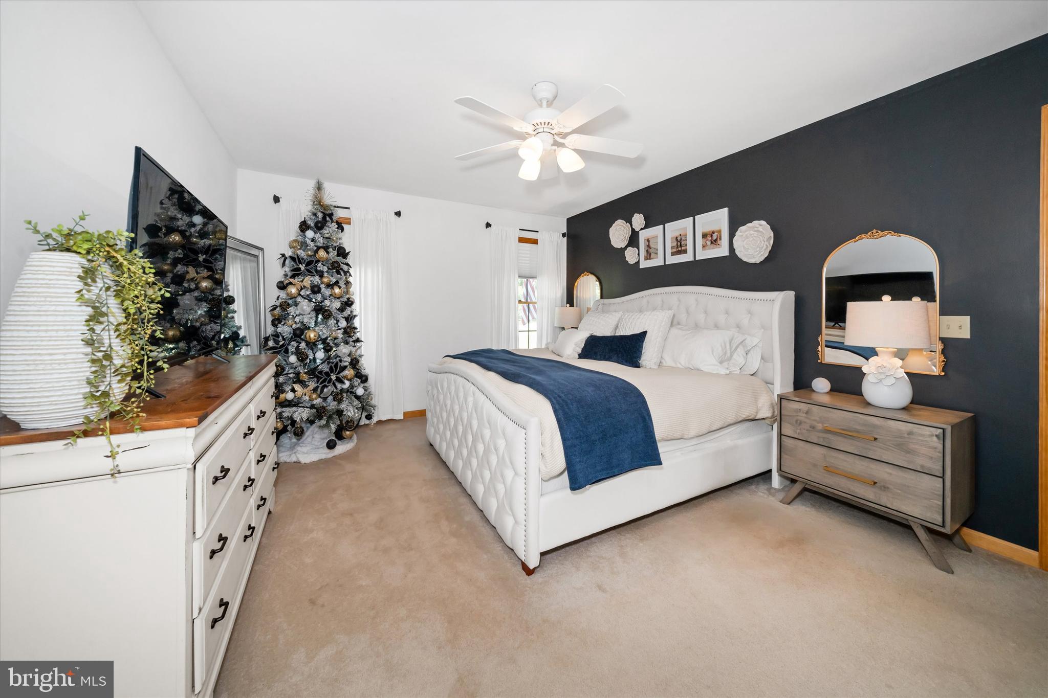 1265 Bowman Road Milford, DE 19963 - Photo 25 of 60 a spacious bedroom with a bed and a chandelier