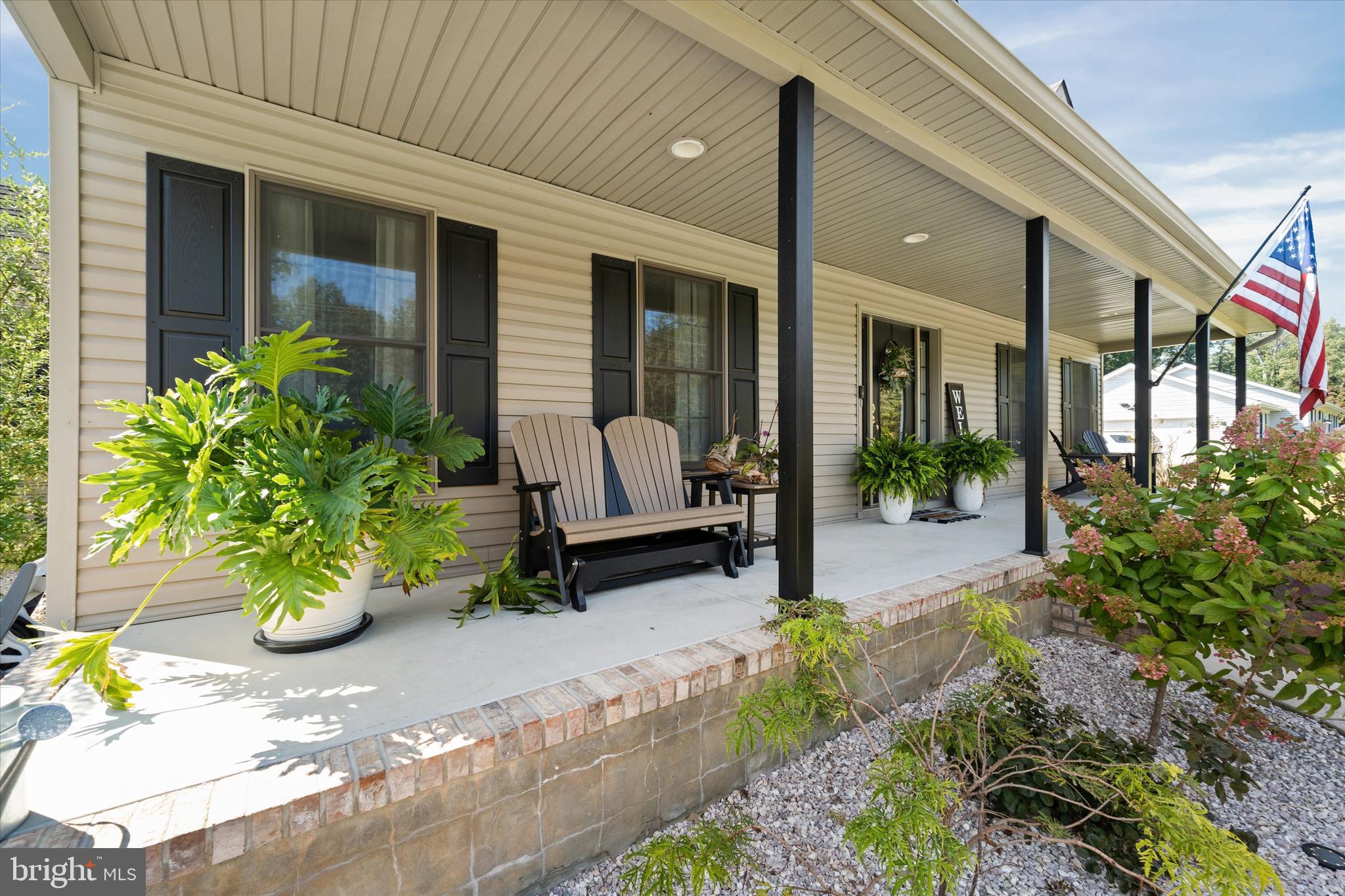 1265 Bowman Road Milford, DE 19963 - Photo 3 of 60 a front view of a house with a chairs and potted plant
